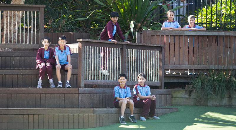 Students sitting around the treehouse at St Bernadette's Primary School Dundas Valley