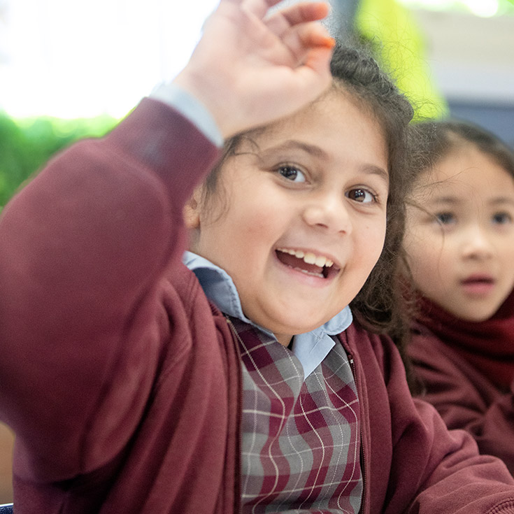 Student waving at the camera at St Bernadette's Primary School Dundas Valley