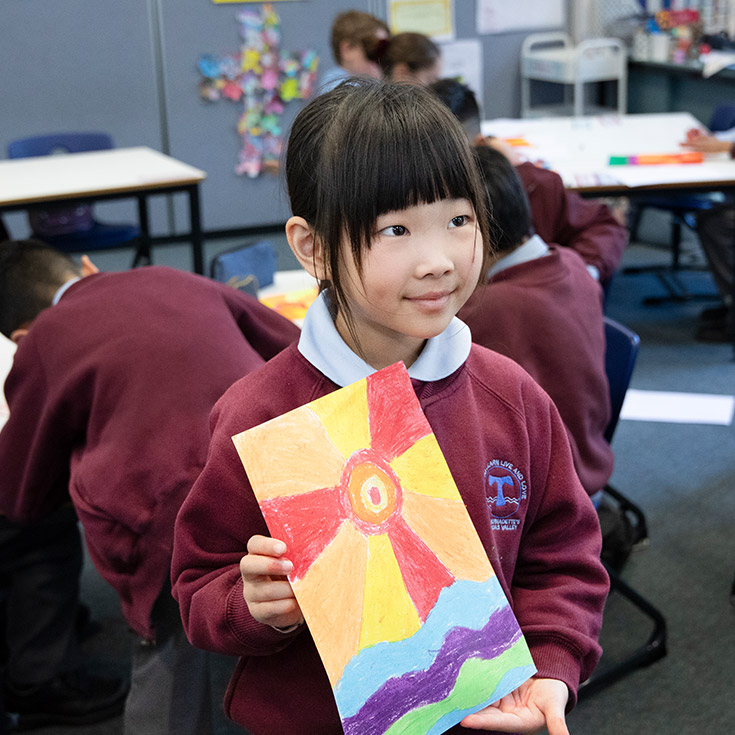 Student presenting her artwork in the classroom at St Bernadette's Primary School Dundas Valley