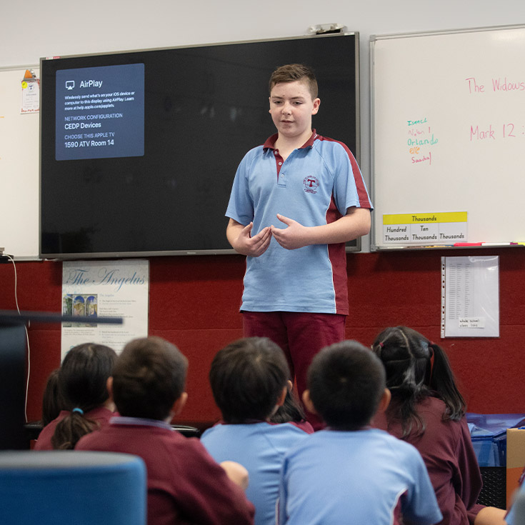 Student standing in front of his class at St Bernadette's Primary School Dundas Valley