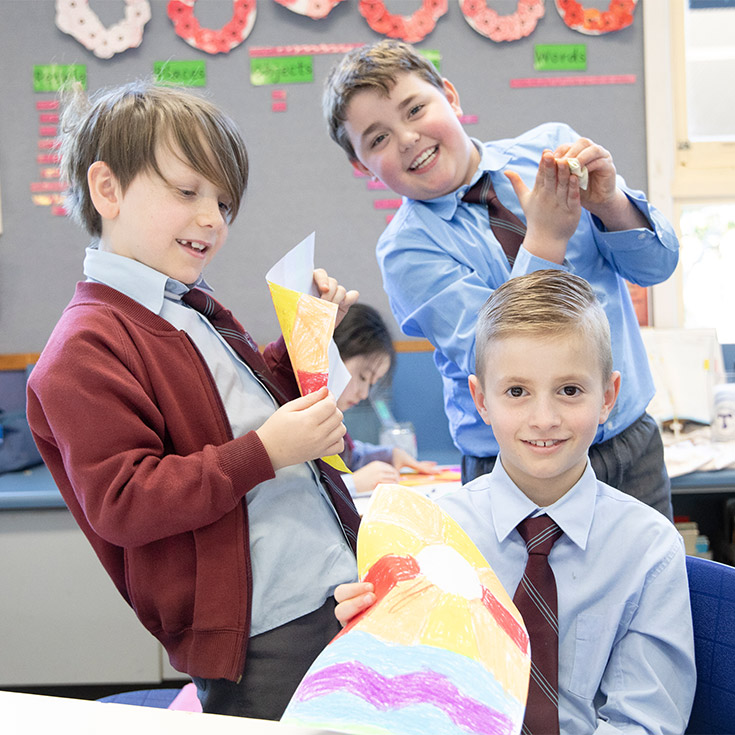 Students showing off their artworks in the classroom at St Bernadette's Primary School Dundas Valley