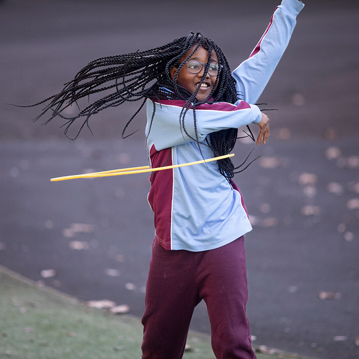 Student playing with a hula hoop at St Bernadette's Primary School Dundas Valley